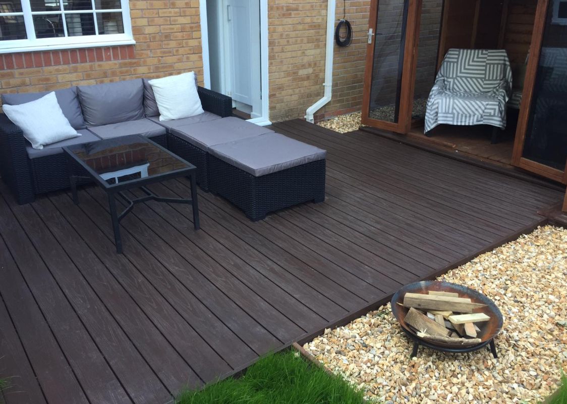 Alchemy Urban decking in a small back garden with furniture and a fire pit