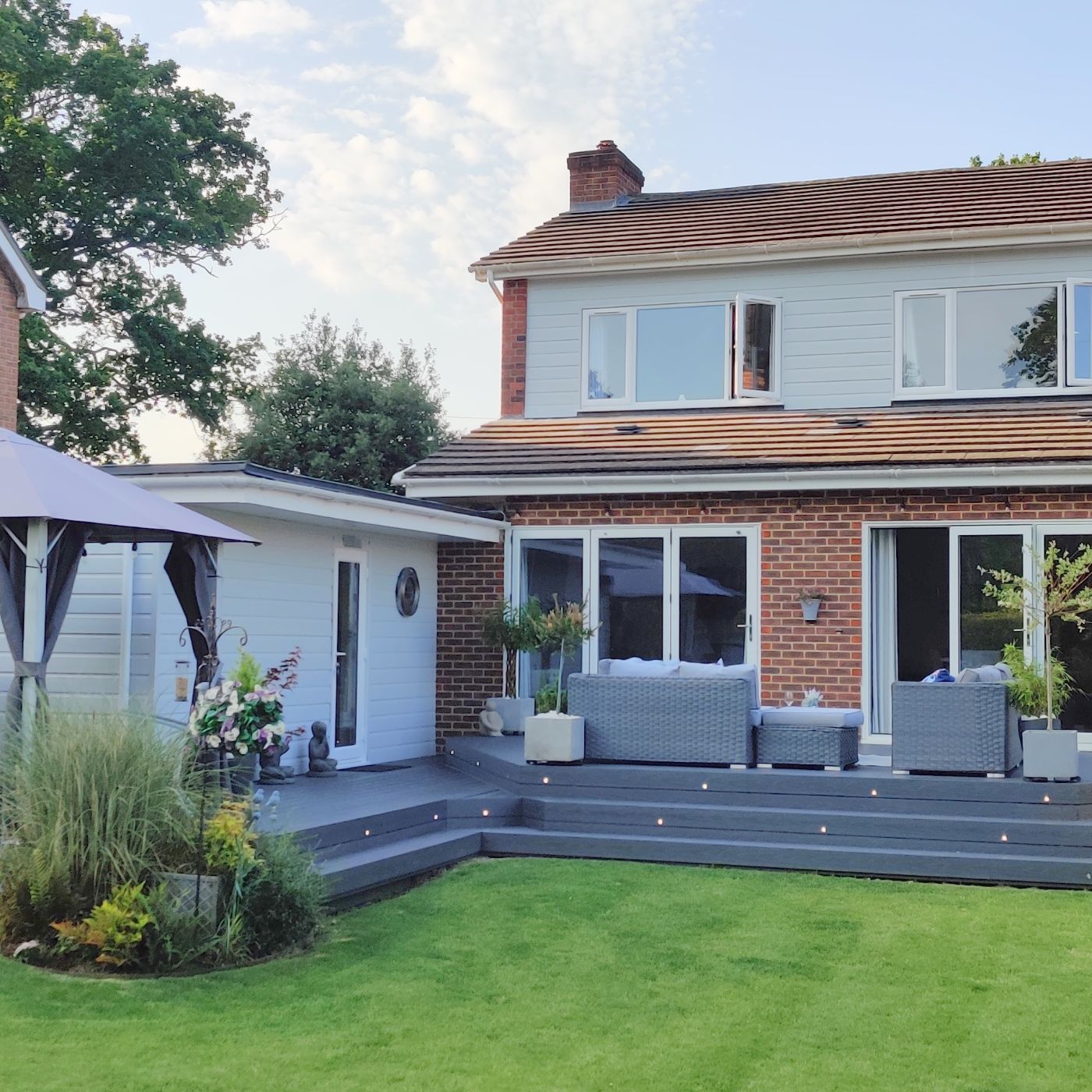Alchemy Urban decking outside a family home with furniture and plants added