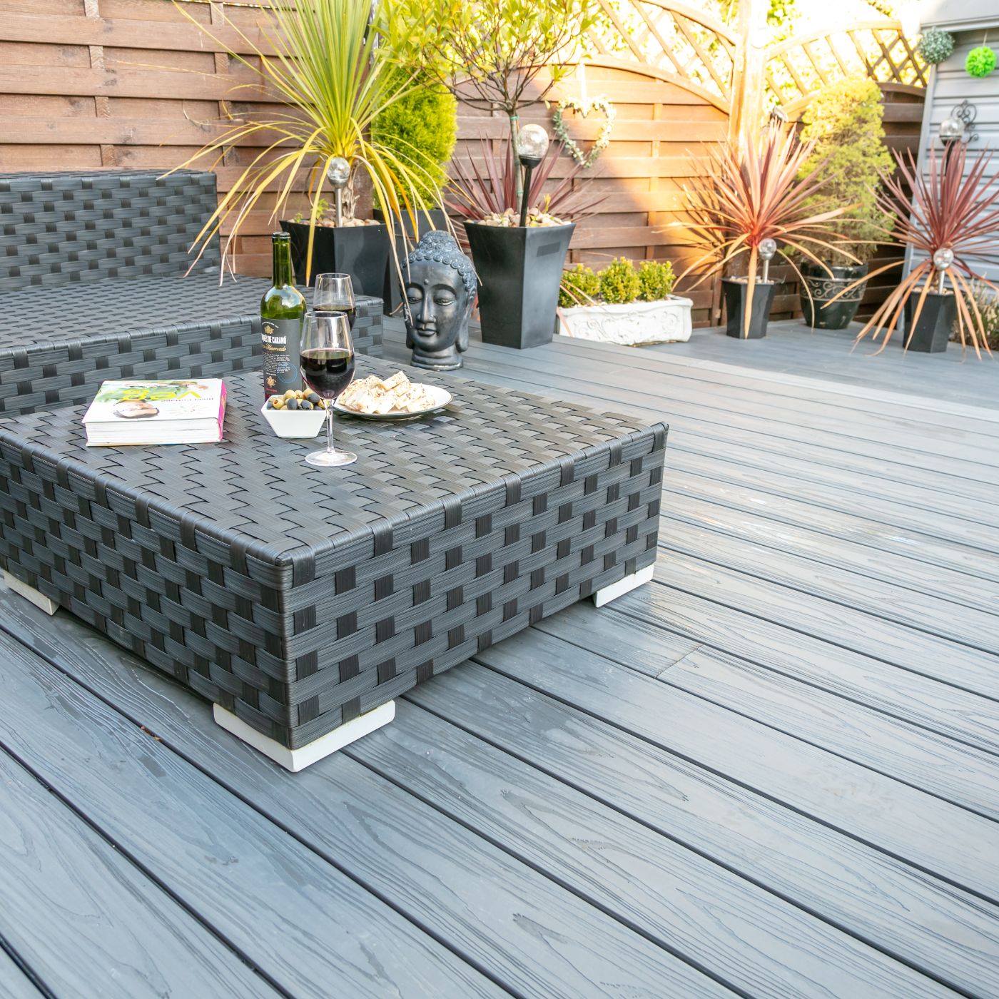 Close up of Alchemy Urban decking with a table accompanied with glasses of wine